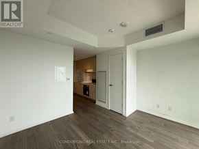 Toronto (Mount Pleasant East) condo for rent - A spacious room with a kitchenette in the background.