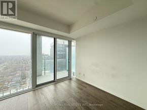 Toronto (Mount Pleasant East) condo for rent - A room with a large window overlooking a cityscape.