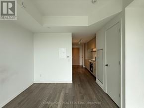 Toronto (Mount Pleasant East) condo for rent - A room with a white wall and a wooden floor.