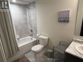 Collingwood townhouse for rent - A bathroom with a toilet, sink, and shower.