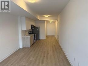 Kitchener townhouse for rent - A long hallway with a kitchen area on the left side.
