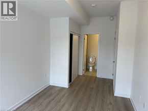 Kitchener townhouse for rent - A room with a toilet in the middle and a door on the right.
