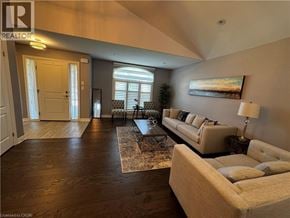 Niagara Falls apartment for rent - A living room with a couch, coffee table, and a painting on the wall.
