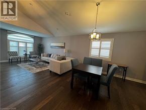 Niagara Falls apartment for rent - A well-lit living room with a dining table and chairs.
