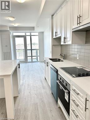 Hamilton condo for rent - A kitchen with white cabinets and a blue oven.