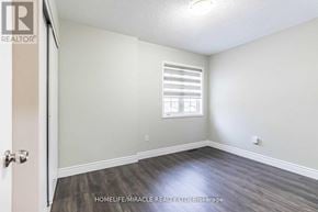 Brampton (Fletcher's Meadow) apartment for rent - A room with a door, window, and wooden flooring.