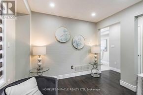 Brampton (Fletcher's Meadow) apartment for rent - A living room with a couch, two lamps, and two decorative plates on the wall.