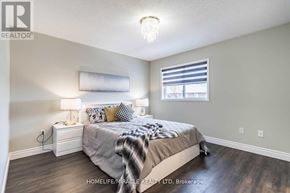 Brampton (Fletcher's Meadow) apartment for rent - A bedroom with a bed, nightstand, and window.
