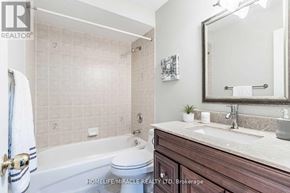 Brampton (Fletcher's Meadow) apartment for rent - A bathroom with a white tub, sink, and a mirror.
