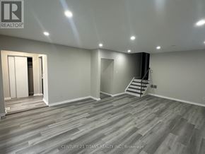 Toronto (Woburn) apartment for rent - A room with wooden flooring and a staircase in the corner.