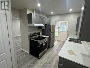 Toronto (Woburn) apartment for rent - A modern kitchen with a stove top oven and a refrigerator.
