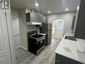 Toronto (Woburn) apartment for rent - A modern kitchen with a stove top oven and a refrigerator.