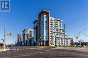 Hamilton (Waterdown) condo for rent - A large building with many windows is being advertised by RE/MAX Escarpment Realty Inc.