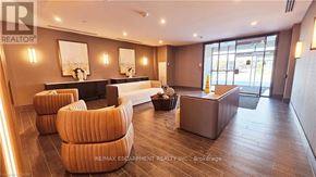 Hamilton (Waterdown) condo for rent - A reception area with a desk, chairs, and a fireplace.