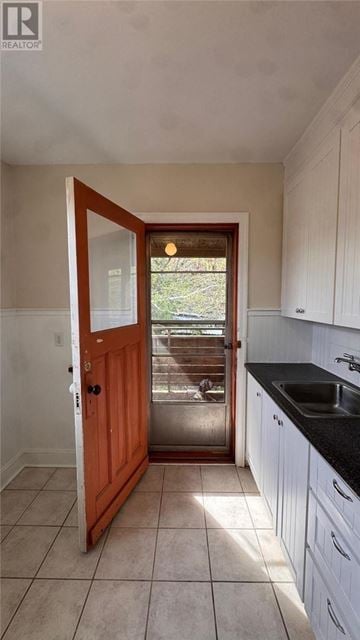 Sudbury apartment for rent - A kitchen with a sink and a wooden door.