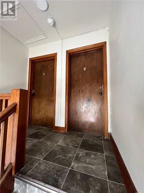 Sudbury apartment for rent - A hallway with two doors and a tiled floor.