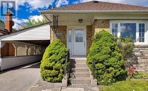 Toronto (Wexford-Maryvale) apartment for rent - A house with a white door and windows is surrounded by green bushes.