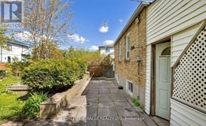 Toronto (Wexford-Maryvale) apartment for rent - A narrow alleyway between two houses with a sign for HomeLife/Miracle Realty LTD Brokerage.