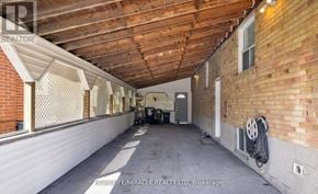 Toronto (Wexford-Maryvale) apartment for rent - A spacious attic room with wooden beams and a window with blinds.