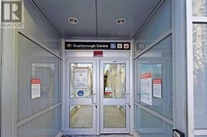 Toronto (Bendale) condo for rent - The interior of a building with a glass door and a sign that reads "Scarborough Centre".