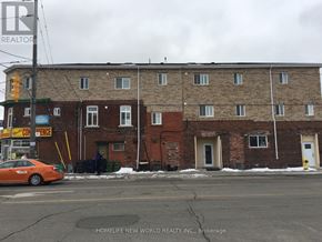 Toronto (Rockcliffe-Smythe) townhouse for rent - A car is parked on the street in front of a building.