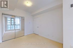 Toronto (Waterfront Communities) condo for rent - A room with white walls and a large mirror on the wall.