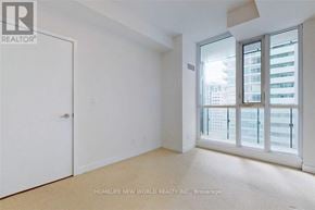 Toronto (Waterfront Communities) condo for rent - A room with a large window and a sliding glass door.