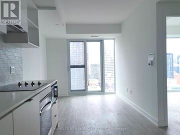 Toronto (Church-Yonge Corridor) condo for rent - A modern kitchen with a stove top oven and a large window.