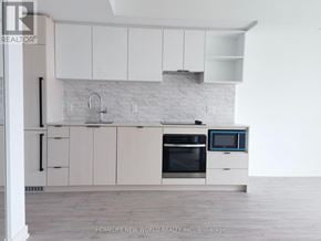 Toronto (Church-Yonge Corridor) condo for rent - A white kitchen with a white brick backsplash and white cabinets.