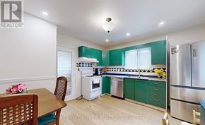 Newmarket (Central Newmarket) apartment for rent - A kitchen with green cabinets and a wooden table.