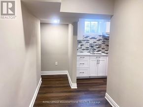 Milton (Cb Cobban) apartment for rent - A kitchen with white cabinets and a tile backsplash.