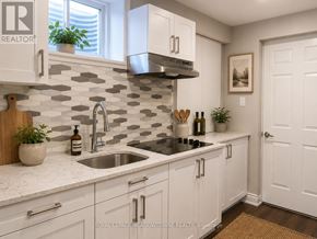 Milton (Cb Cobban) apartment for rent - A kitchen with white cabinets and a checkered backsplash.
