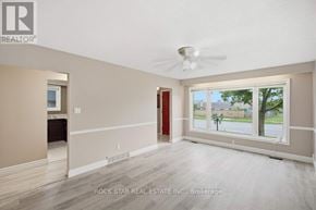 Hamilton (Vincent) apartment for rent - A room with a ceiling fan and a window overlooking a street.