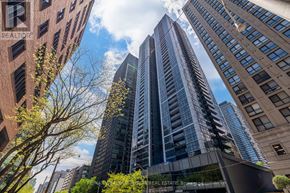 Toronto (Church-Yonge Corridor) condo for rent - A tall building with the words RE/MAX VESTA BROKERAGE BROKER REAL ESTATE BROKERED in the foreground.