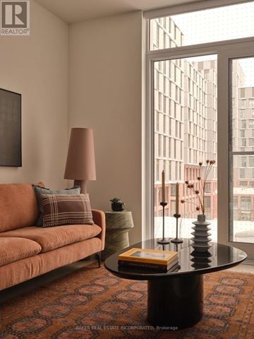 Toronto (Waterfront Communities) condo for rent - A living room with a couch, a table, and a window.