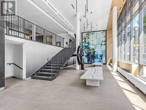 Toronto (Waterfront Communities) condo for rent - A staircase with a metal railing and a glass wall.