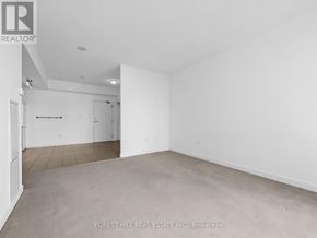 Toronto (Waterfront Communities) condo for rent - A large, empty room with a carpeted floor and white walls.