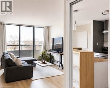 Toronto condo for rent - A living room with a grey couch and a television.