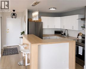Toronto condo for rent - A modern kitchen with white cabinets and a wooden island.