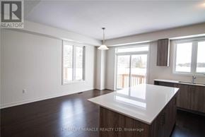 Barrie apartment for rent - A spacious kitchen with a large island in the middle.