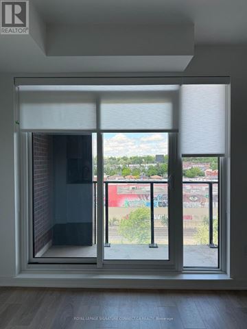 Toronto (Dovercourt-Wallace Emerson-Junction) condo for rent - A window with a view of a graffiti covered wall outside.