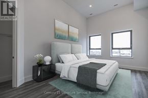 Hamilton (Beasley) condo for rent - A bedroom with a large bed and a painting on the wall.