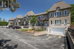 Russell condo for rent - A row of houses with garages in front of them.