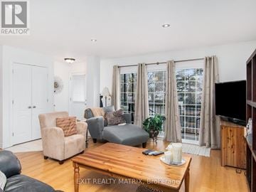 Russell condo for rent - A living room with a wooden coffee table and a flat screen TV.