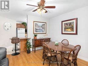Russell condo for rent - A dining room with a table set for two and a framed picture on the wall.
