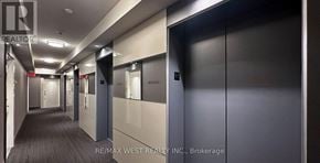 Toronto (Bay Street Corridor) condo for rent - A hallway with doors on both sides and a sign that says REALTOR.