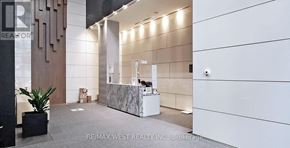 Toronto (Bay Street Corridor) condo for rent - A reception area with a counter and a plant.