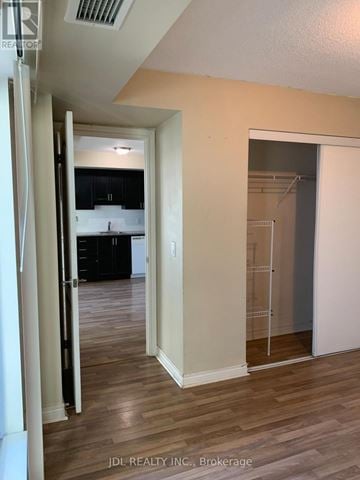 Toronto (Bendale) condo for rent - A hallway with a glass door leading to a kitchen.