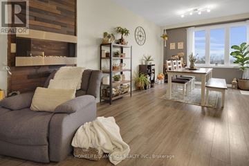 London North (North M) townhouse for rent - A living room with a grey couch and a wooden fireplace.
