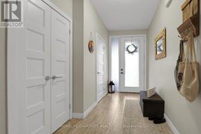 London North (North M) townhouse for rent - A hallway with a white door, a mirror, and a wreath on the door.
